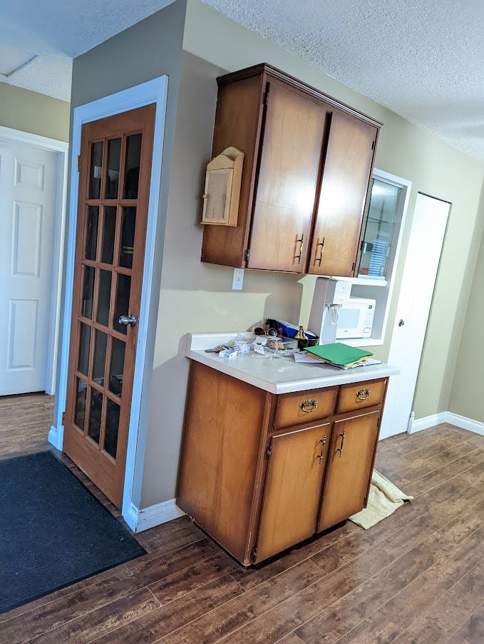Downstairs stairwell with sunburst wooden cupboards