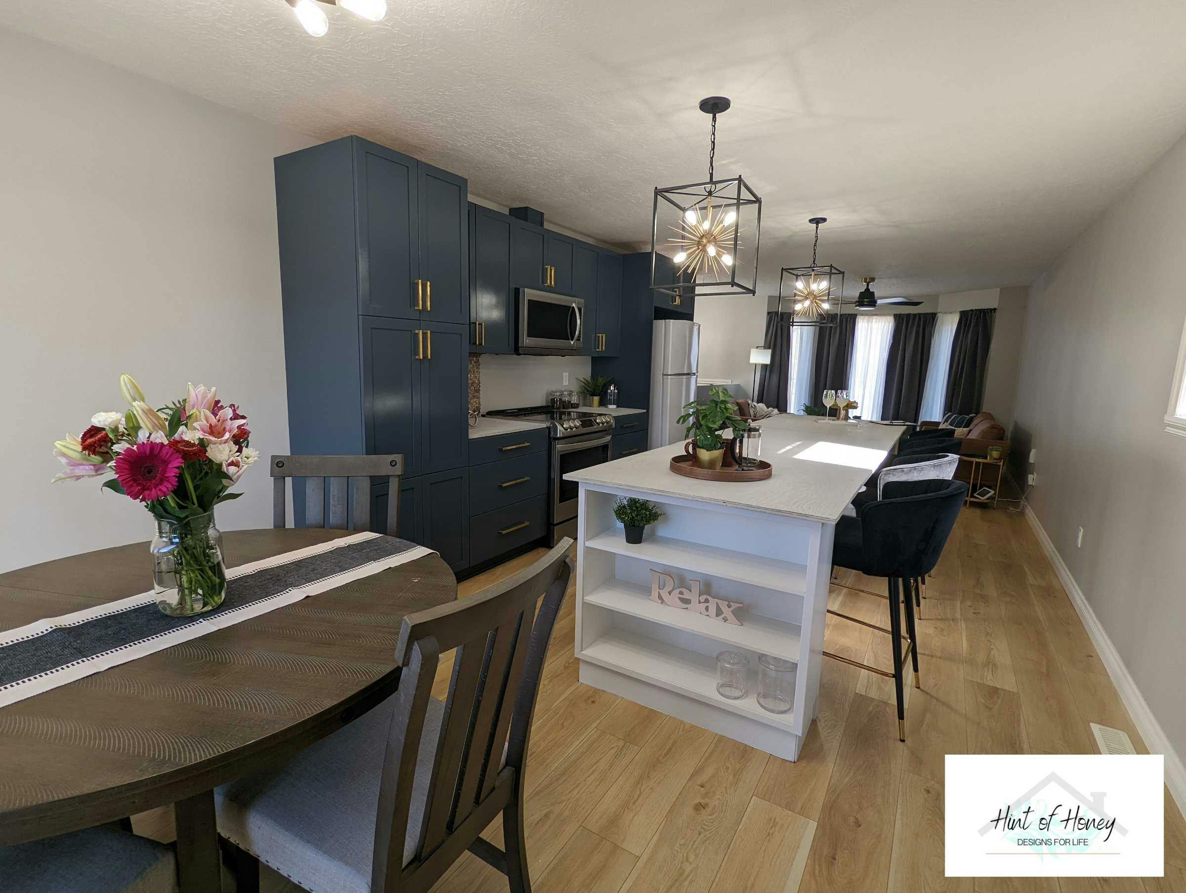 Dining room and kitchen with deep blue cupboards