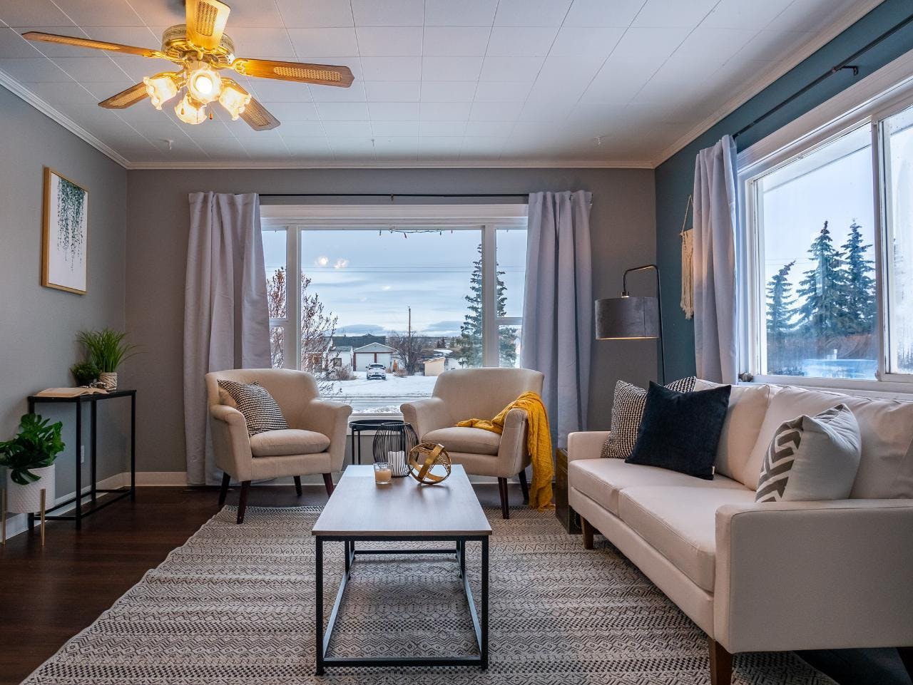 Staged living room with warm yellow lighting and fresh plants