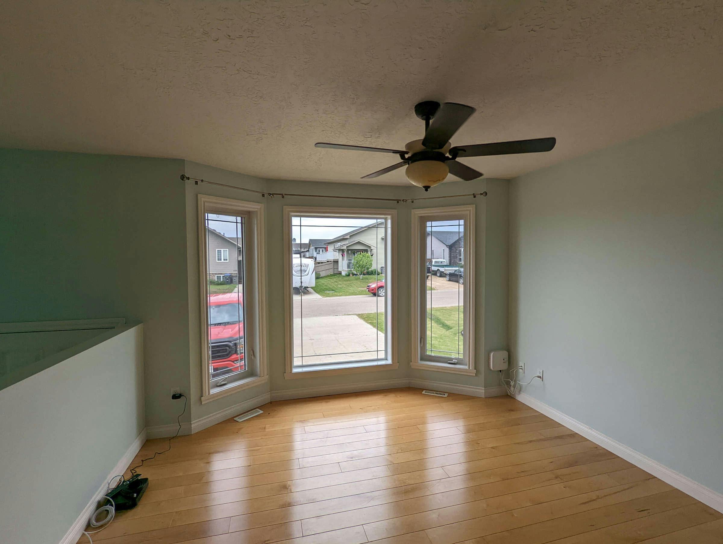 Living room with wood floor and large open windows