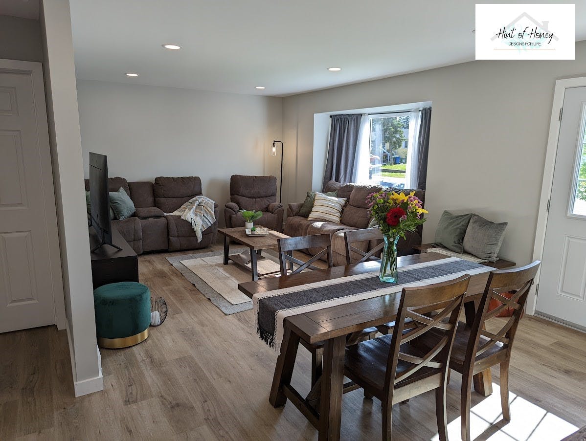 Modernly staged dining room and living room with rustic accents