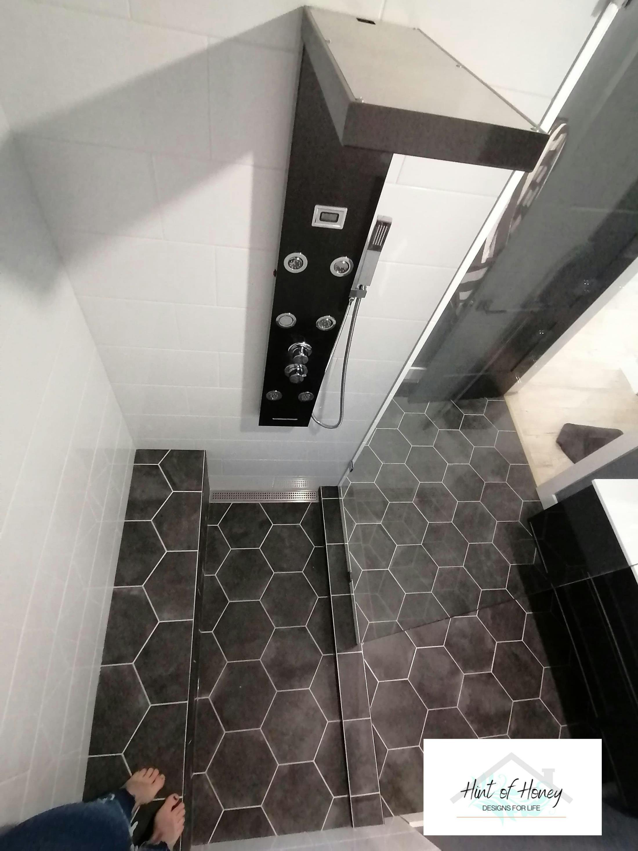 Custom shower with dark octagon floor tiles