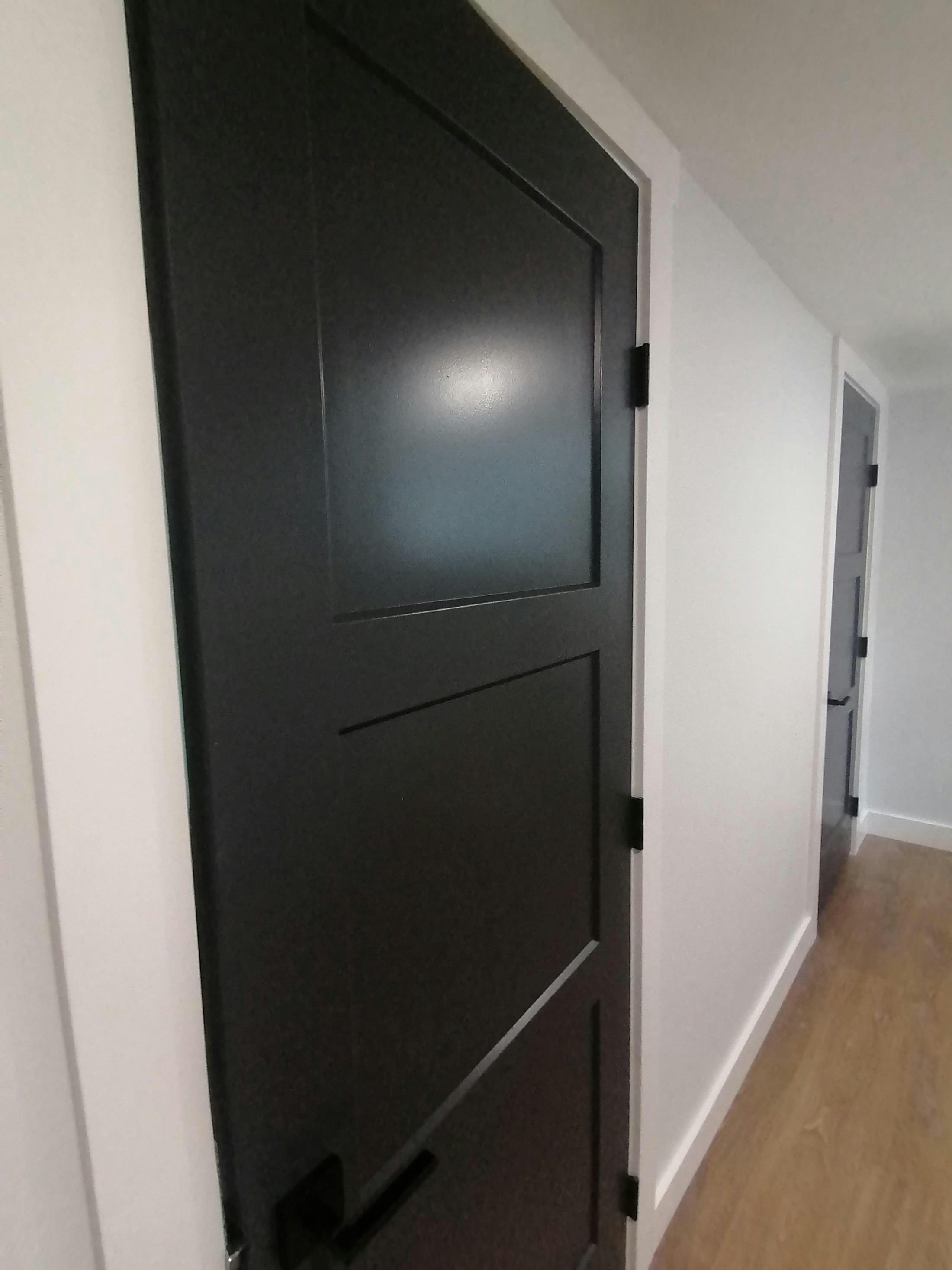 Solid black doors in hallway