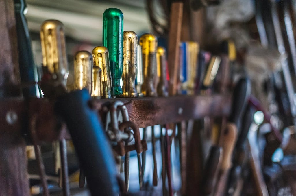 A row of screwdrivers with yellow handles, and one screwdriver with a green handle