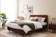 Chambre avec lit en bois sombre massif, un tapis beige, une déco minimaliste et une plante