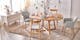 Table de salle à manger Voksa par Ars Natura, une marque exclusive home24, avec de la vaisselle BUTLERS bleu clair et blanche et des décorations de Pâques colorées, ainsi que des chaises grises de style scandinave, une enfilade blanche et un tapis beige.