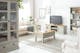 Wohnzimmer im New Country Look mit kassettierten, hellgrauen Holzmöbeln und cremefarbenen Polstermöbeln