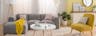 Helles Wohnzimmer mit hellgrauem Sofa, weissem Couchtisch und einer Stehlampe im Skandi-Stil, einem gelben Skandi-Sessel, einer Pendelleuchte aus Muscheln, einem weissen Sideboard und schönen Textilien.