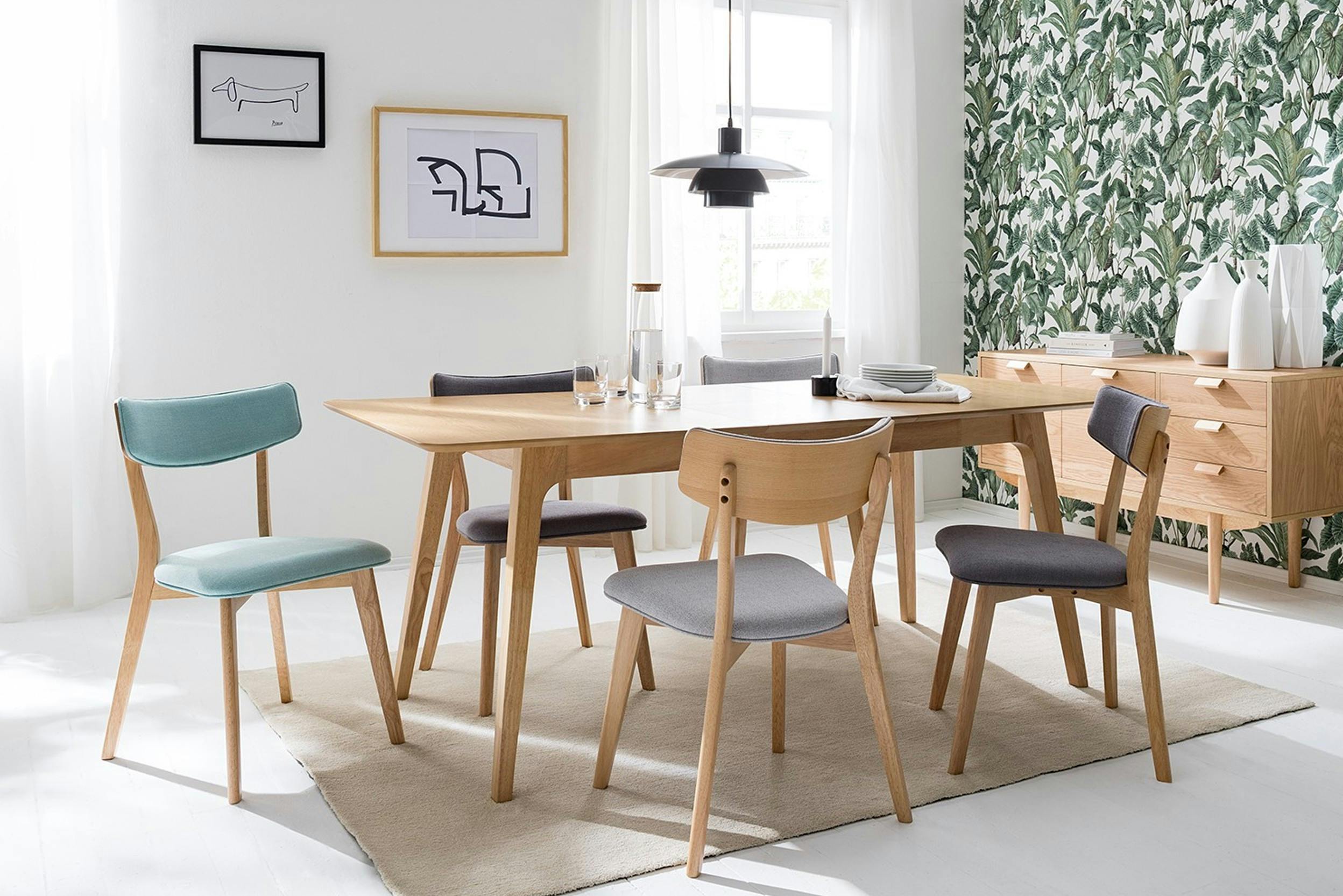 Großer Esstisch mit verschiedenen Stühlen im skandinavischen Stil