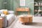 Graues Sofa mit elektrischer Sitztiefenverstellung und Wohnzimmermöbel aus hellem Holz vor einer Wand in Salbeigrün