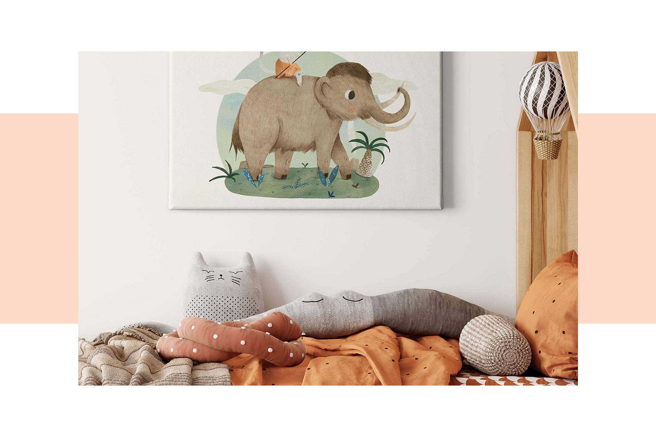 Kinderbett aus Holz mit einer Hausform am Kopfende sowie Bettwäsche und Kuscheltiere in erdigen Farbtönen und einem Bild mit niedlichem Elefanten im Hintergrund