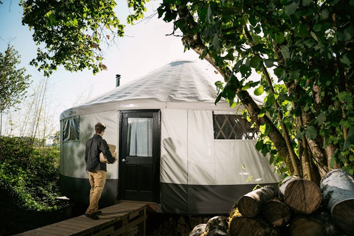 Man entering a modern Yurt
