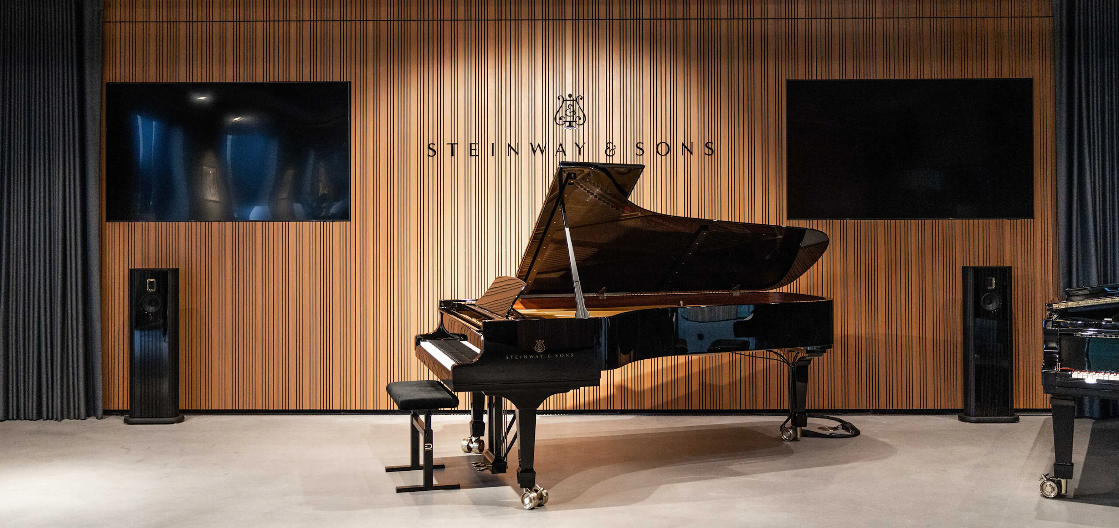Steinway & Sons grand piano flanked by Steinway Lyngdorf loudspeakers