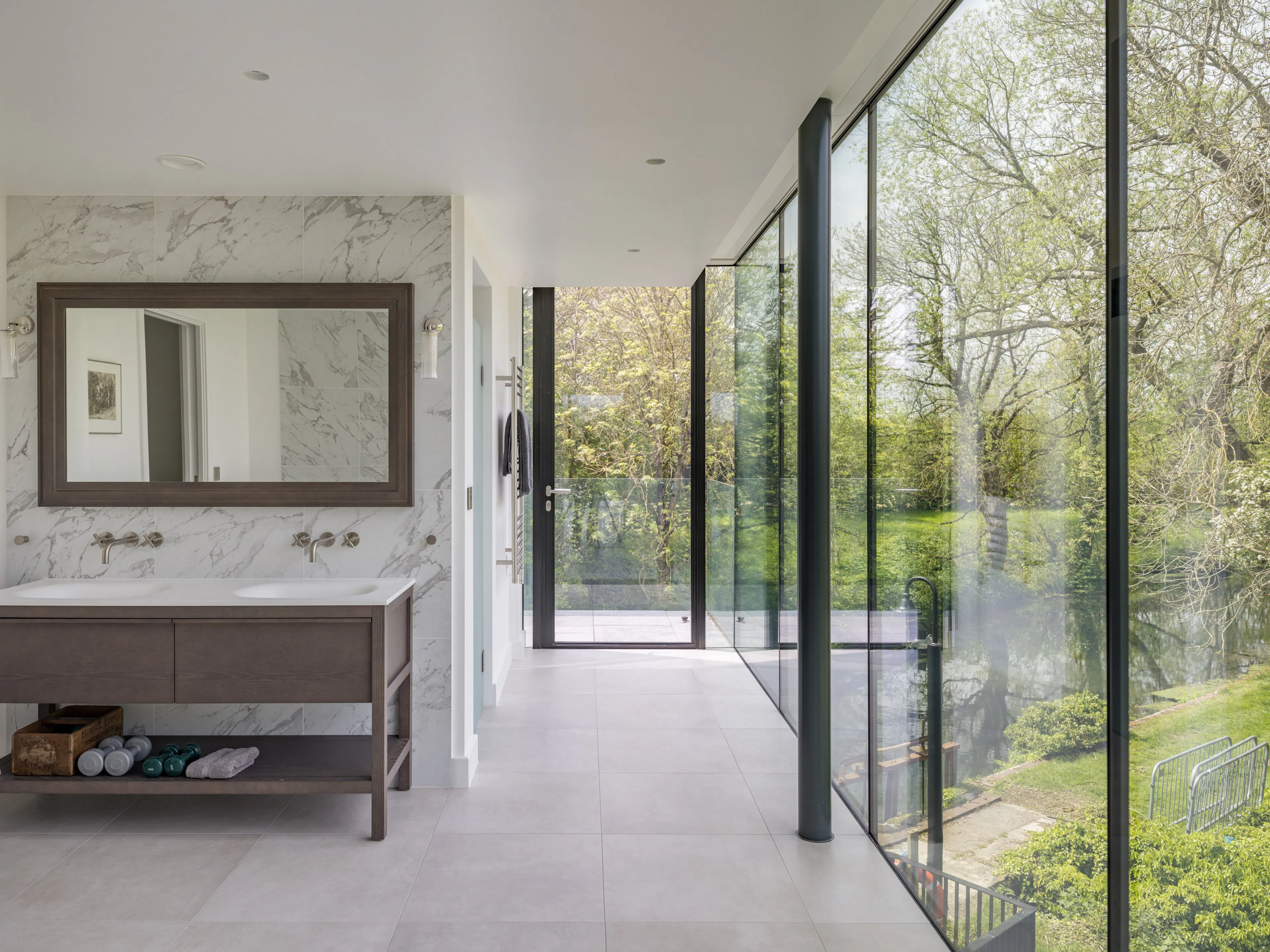 Marble bathroom in the glass wing, glazed from floor to ceiling along the river side