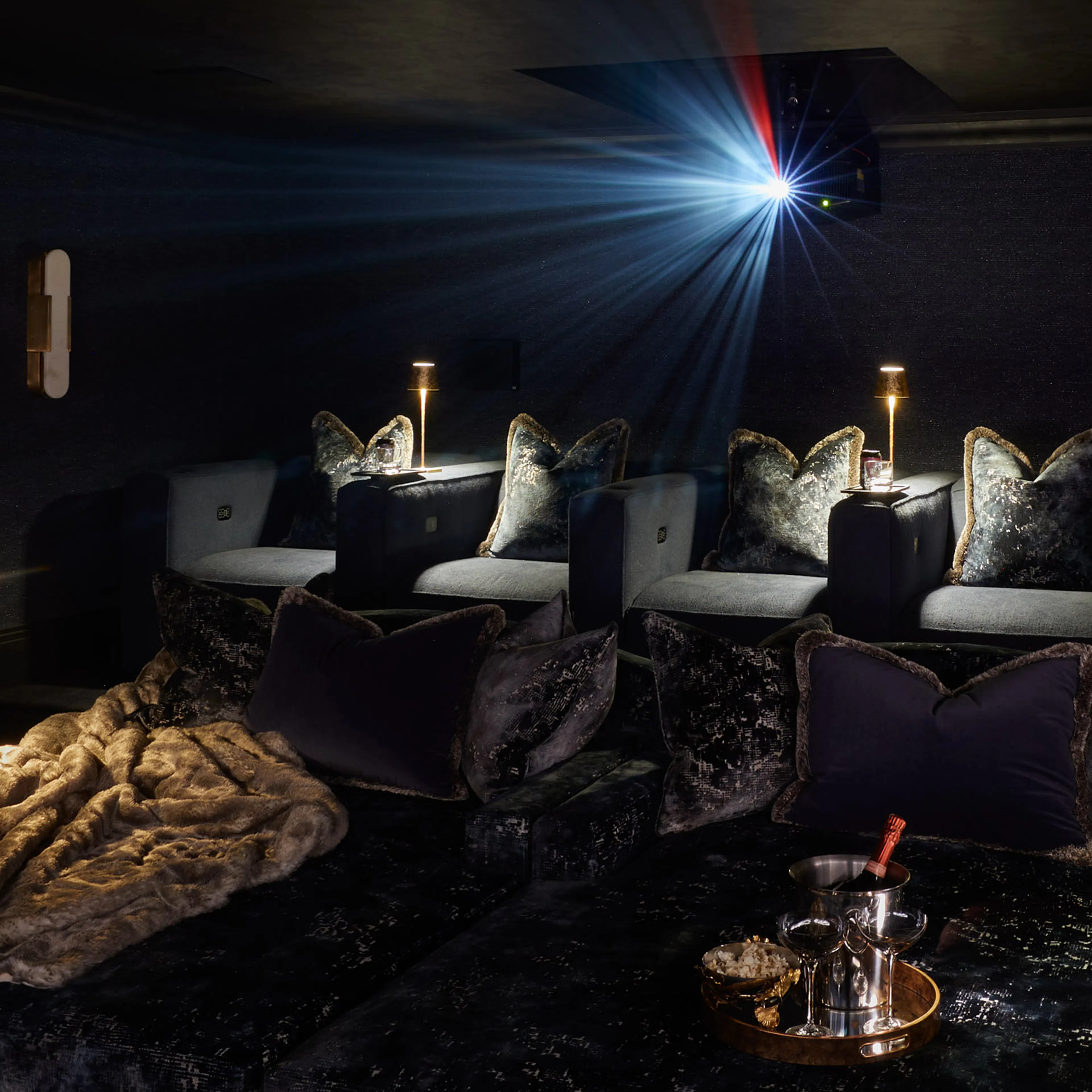 Private cinema room in a Berkshire family home, projector lit above three rows of seating