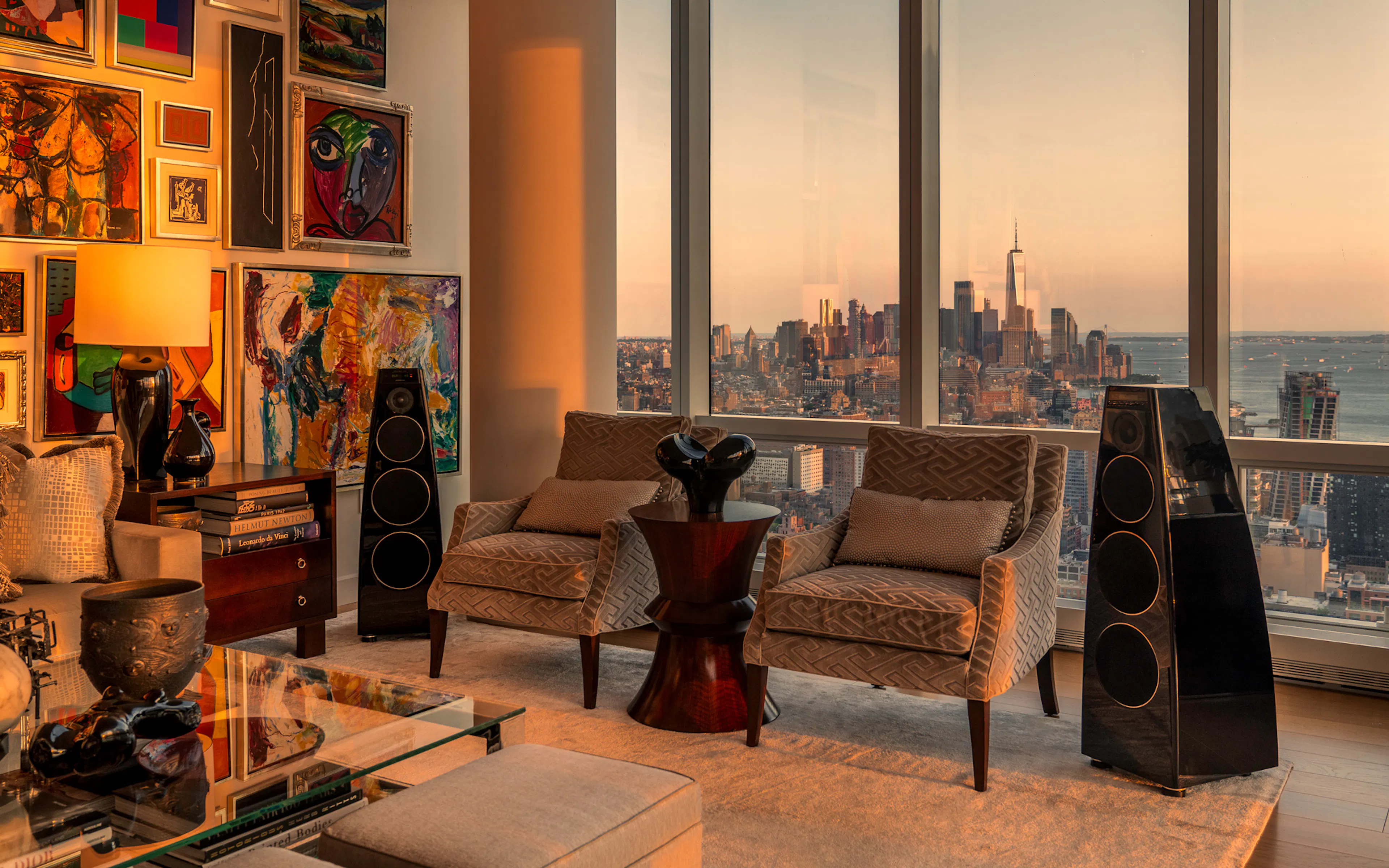Meridian DSP loudspeakers in gloss black in a living room at sunset