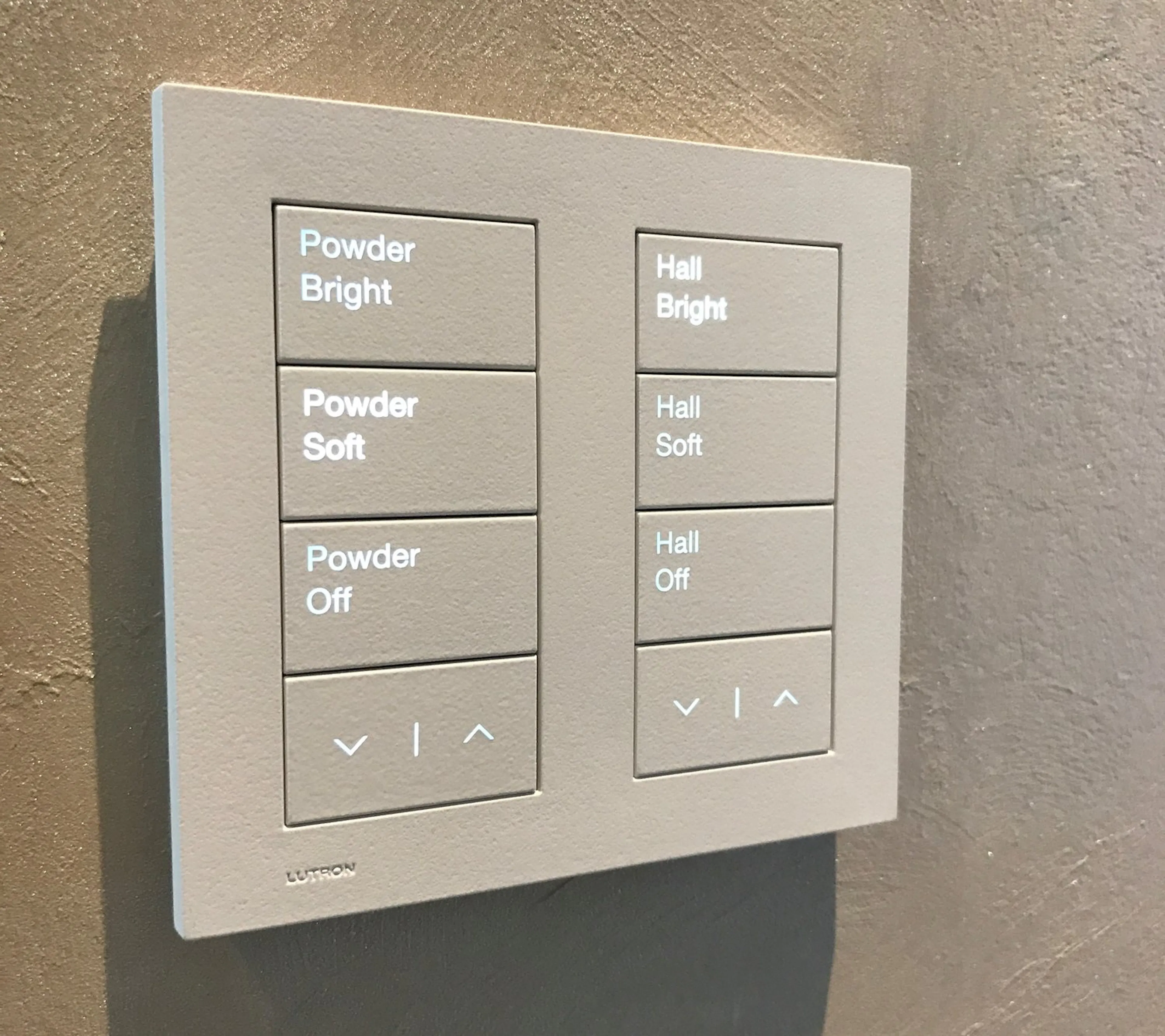 Lutron Palladiom keypad with engraved scene buttons on a plaster wall