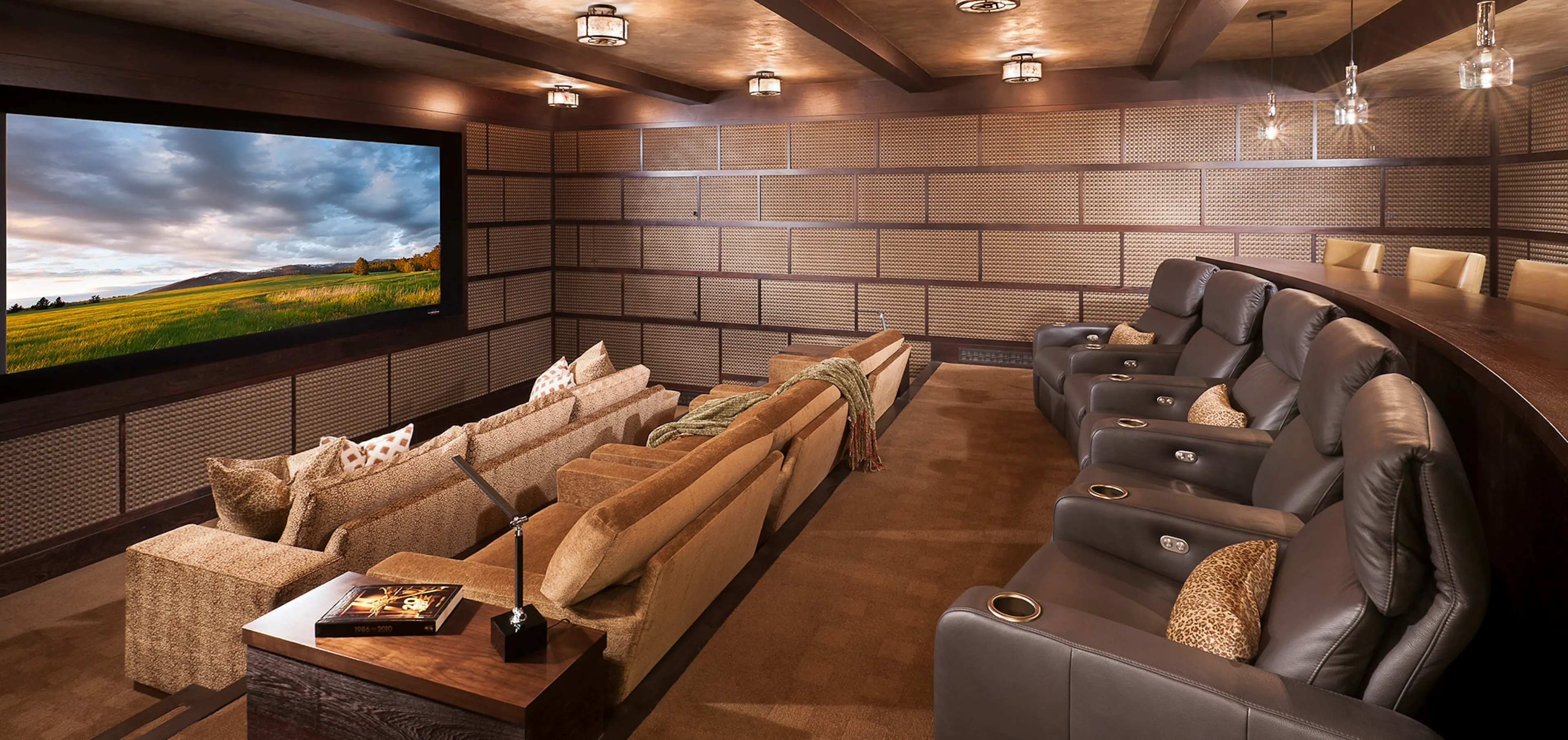 Private cinema with tiered seating and Steinway Lyngdorf speakers concealed behind woven wall panels