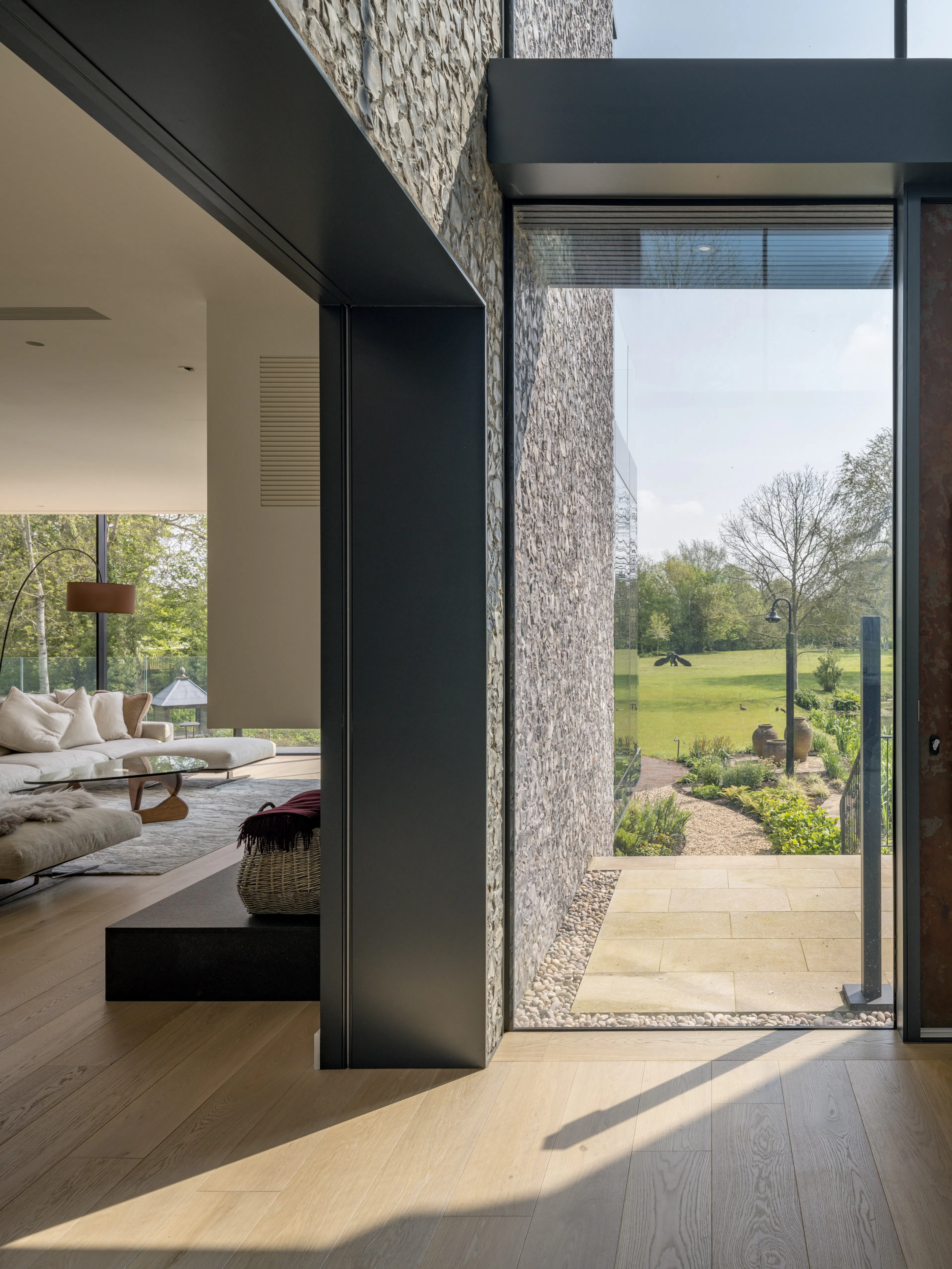 Passage beside the sitting room, with a glazed wall opening onto the garden and the water meadows