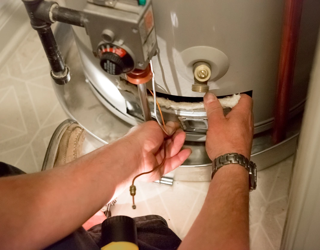 Un technicien de VIK Energies répare un chauffe-eau près de Bricquebec-en-Cotentin dans la Manche
