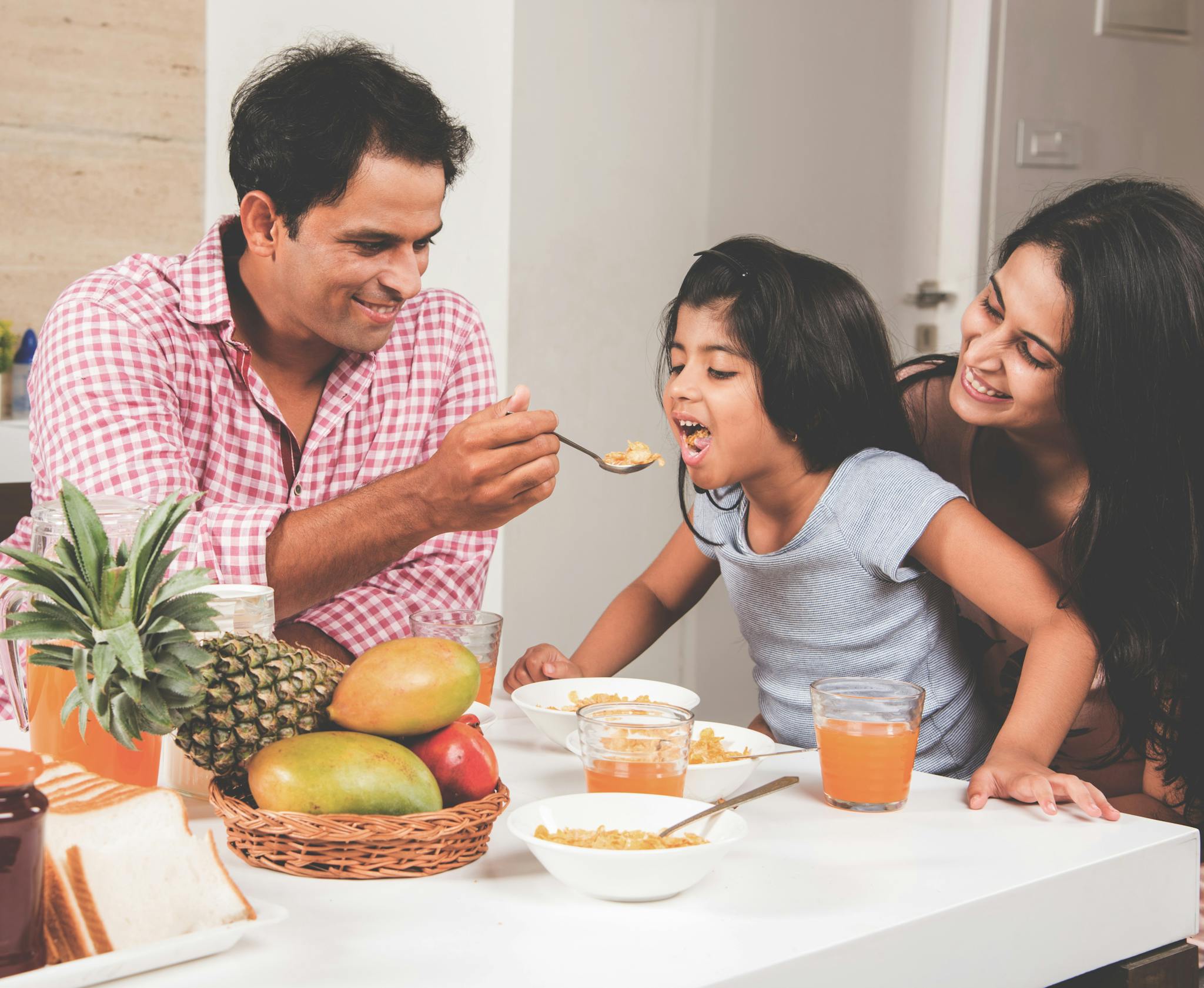 Family eating breakfast together at a table