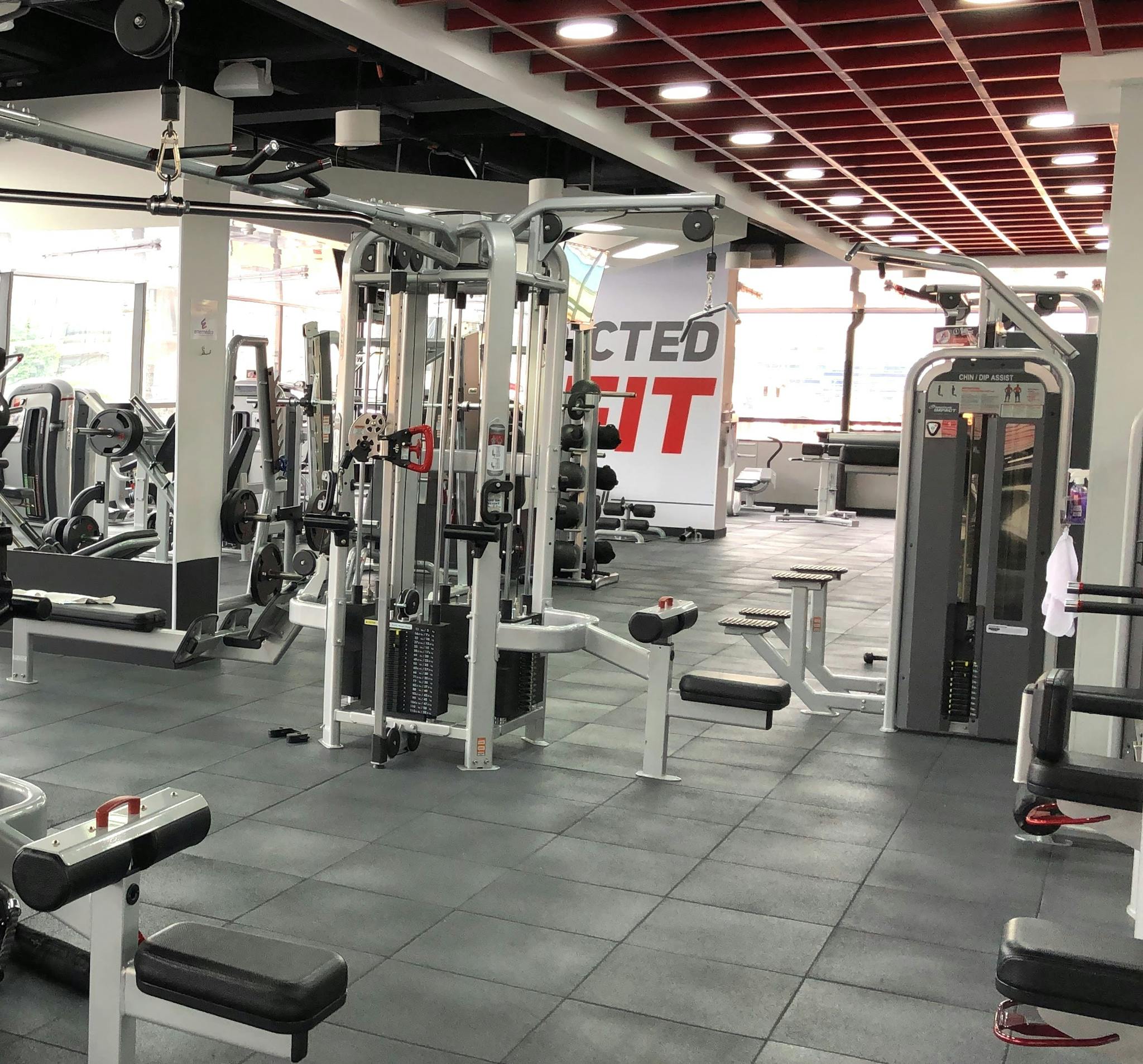 Grey gym with red beams mounted to the roof above