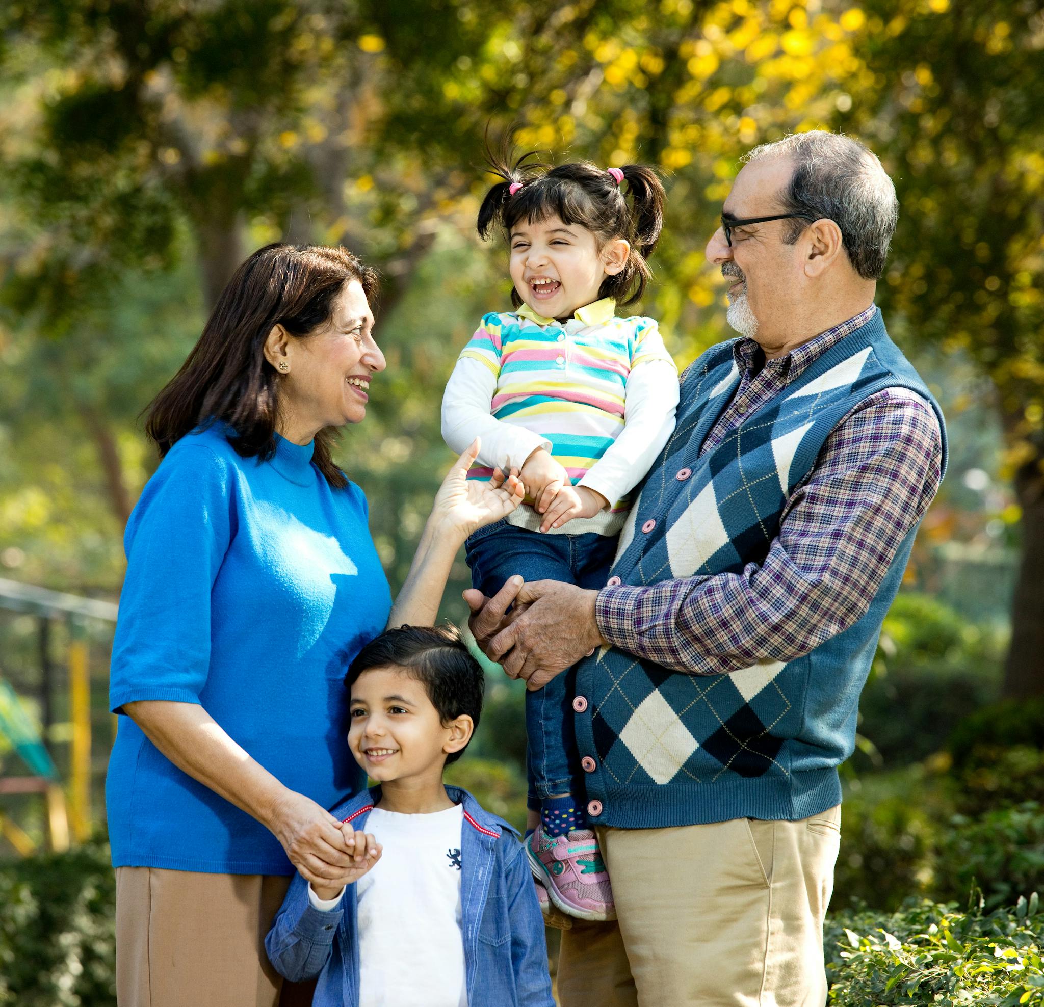 Smiling family in a forested area