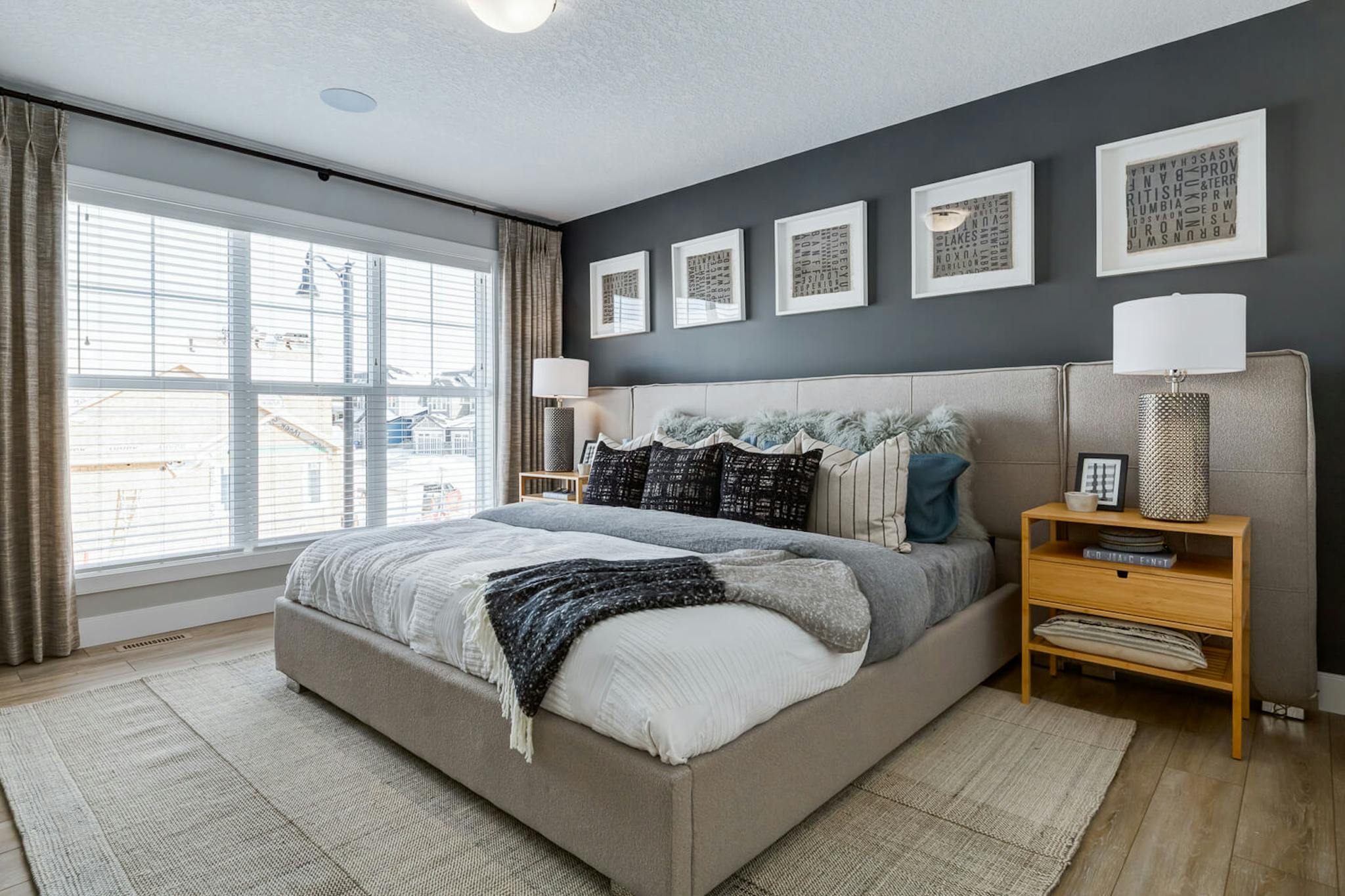 Bedroom with black walls and a beige carpet.