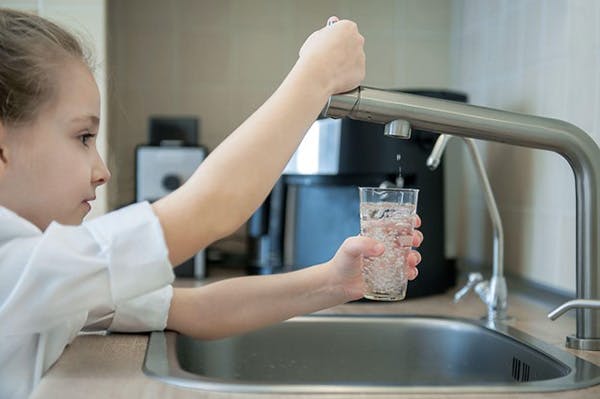 Photo of Girl Getting Filtered Water From Faucet