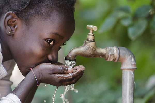 Drinking Water Is Hard Image of Young Girl Drinking From Faucet