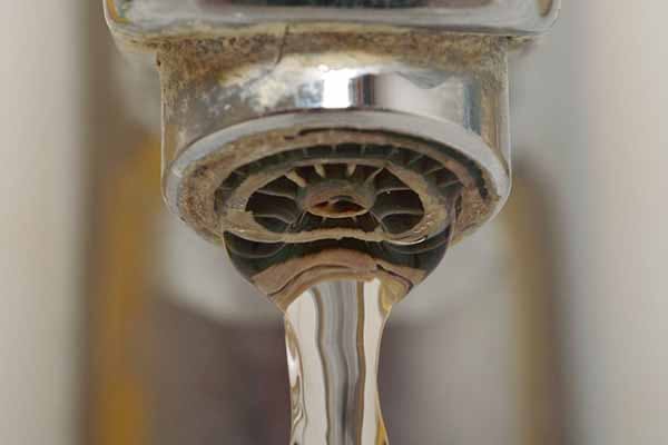 Hard Water a Problem Image of Faucet Running