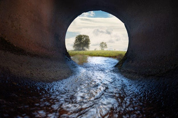 Underground Rushing Water through Sewer Pipe