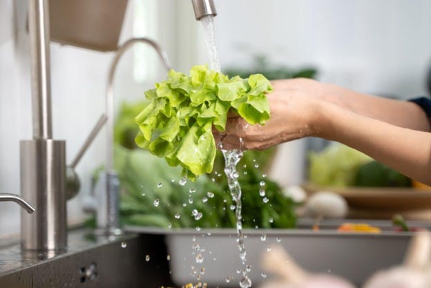 Water Washes Greens Under Sink to Get Rid of Pesticides