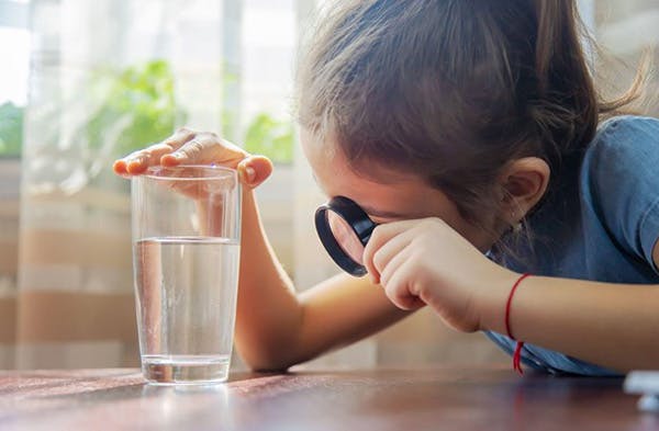 Child Views Houston Texas Drinking Water in Glass Thru Magnifier