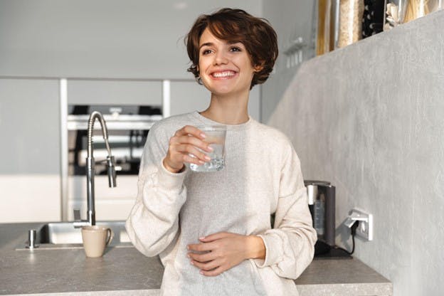 Woman Smiles Drinking Fresh Water