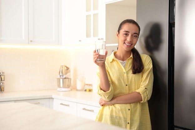 Refrigerator Water Filters Woman Smiles with Fresh Cup