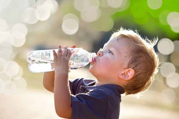 Plastic Water Bottle Photo of Child Drinking From Bottle