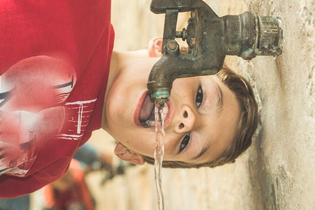 Phoenix Arizona Water Quality Image of Boy Drinking From Faucet