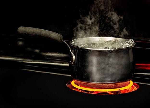 Boiling Water in Pan on Stove