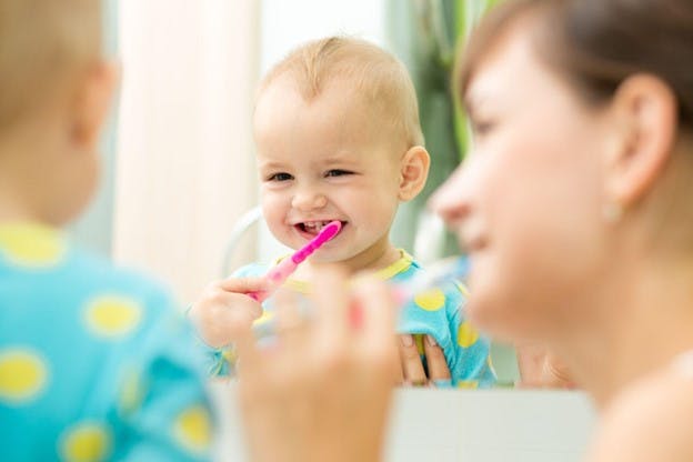 Fluoridated Tap Water Baby Formula Concern Mother Brushes Teeth