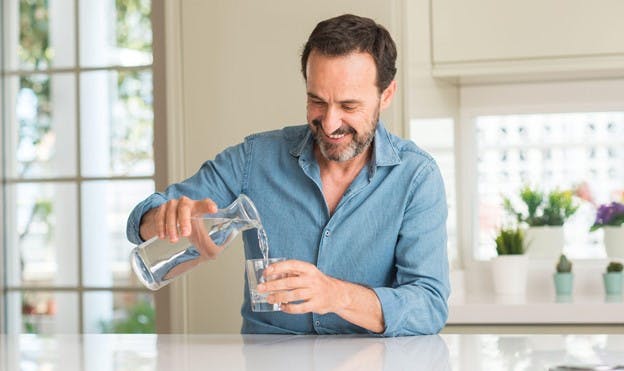 Man Happy As He Pours Artesian Water