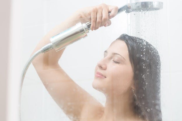 Lady Takes Shower Using Water Filters for Quality Water