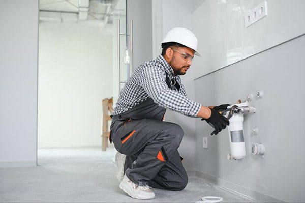 Plumber installs Water Filters in Aurora Building