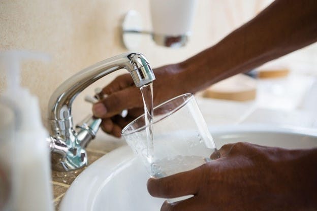 Kansas City Drinking Water Man Fills Glass Under Faucet