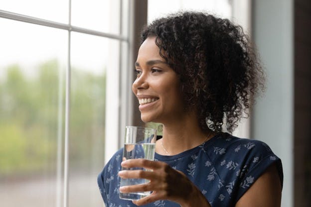 Contaminants From Your Water Happy Lady with Fresh Glass