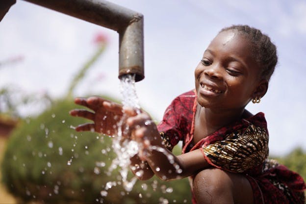 Water Pours out of Outside Pipe Young Girl