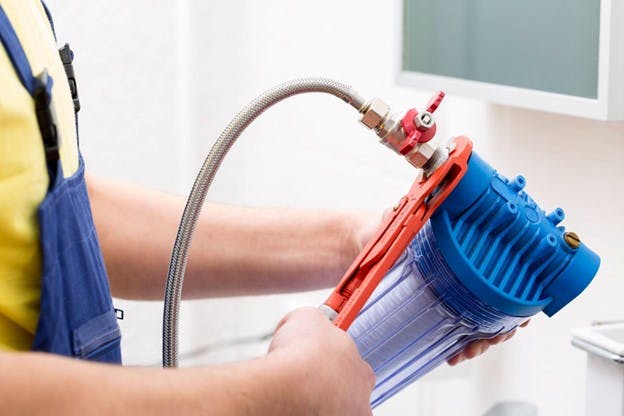 New Water Filtration System Man Holds Filtering System