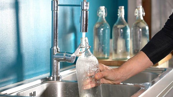 Brampton's Water Quality Man Fills Bottle