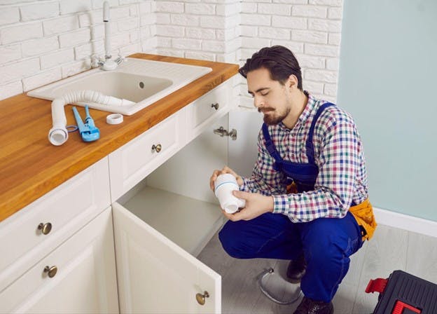 Biodegradable and Eco-Friendly Materials Plumber Installs Under Sink