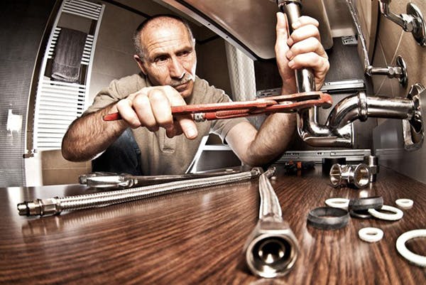 Plumber Works on Faucet Installs Filtered Water